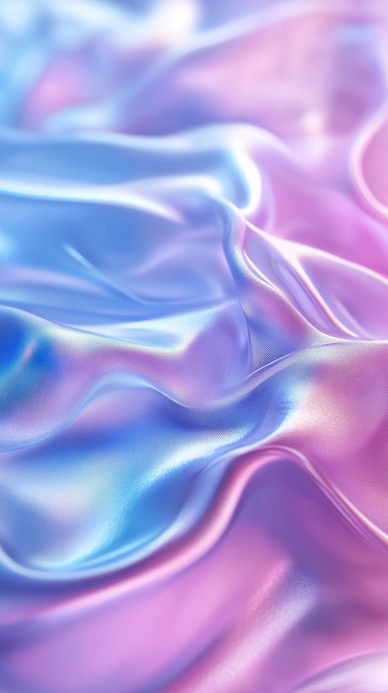 Soft silk fabric draping in gentle waves of blue and pink hues under soft natural light